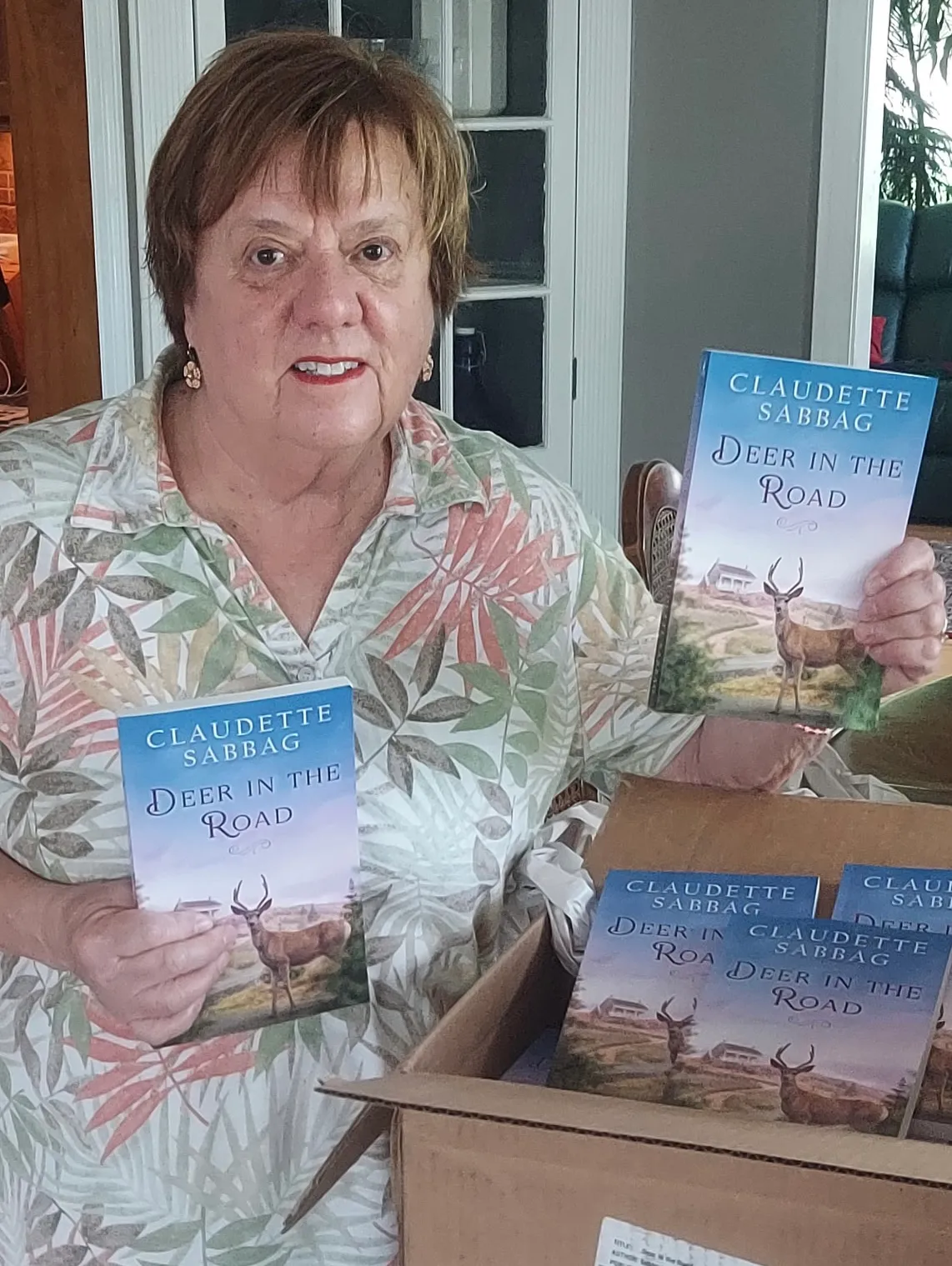 Claudette holding the first paperback copies